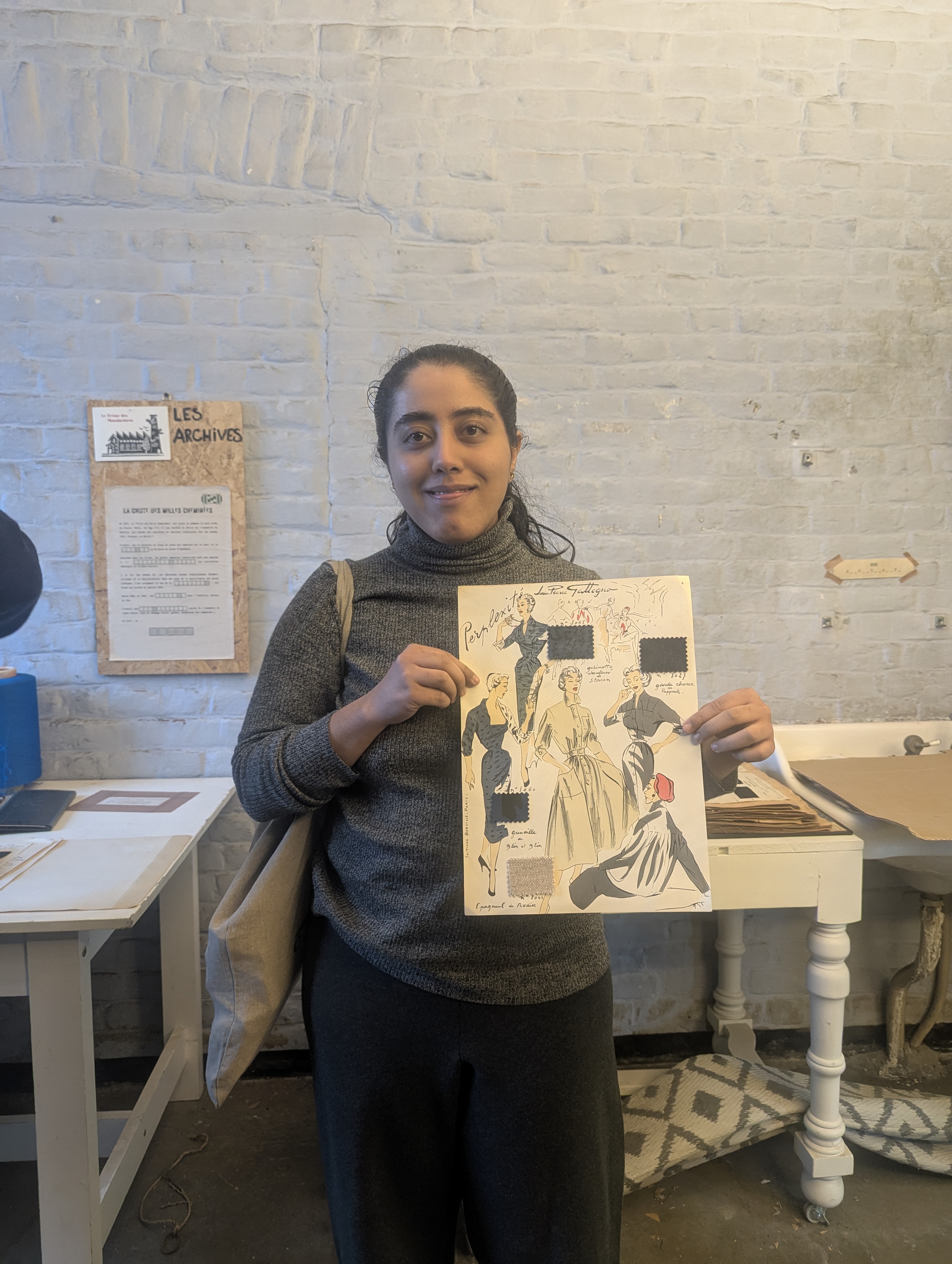 Tanisha holding a historic fashion illustration during a treasure hunt at Tissel in Roubaix